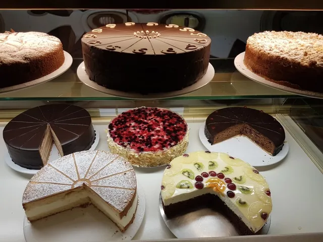 Tarts and cakes from our patisserie, sliced in the display case